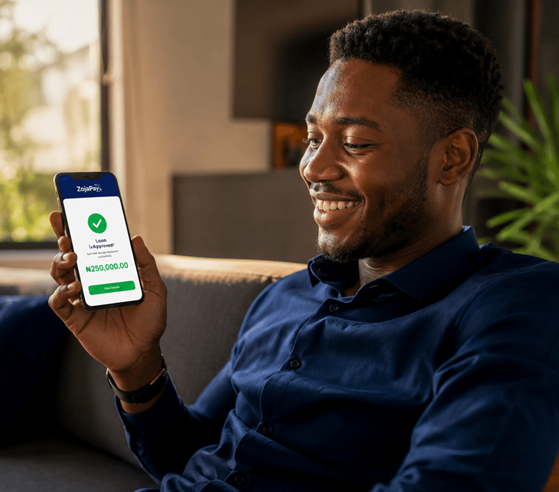 a man holding his phone, displaying an approved loan transaction in the zojapay app